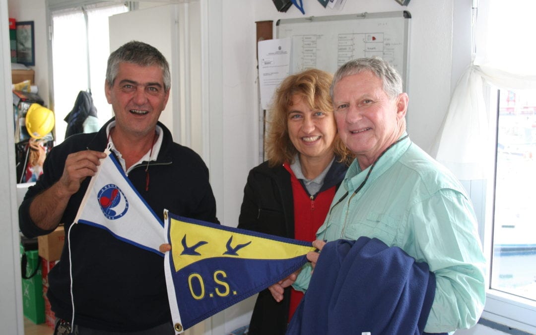 Exchanging club burgee in Savona, Italy.
